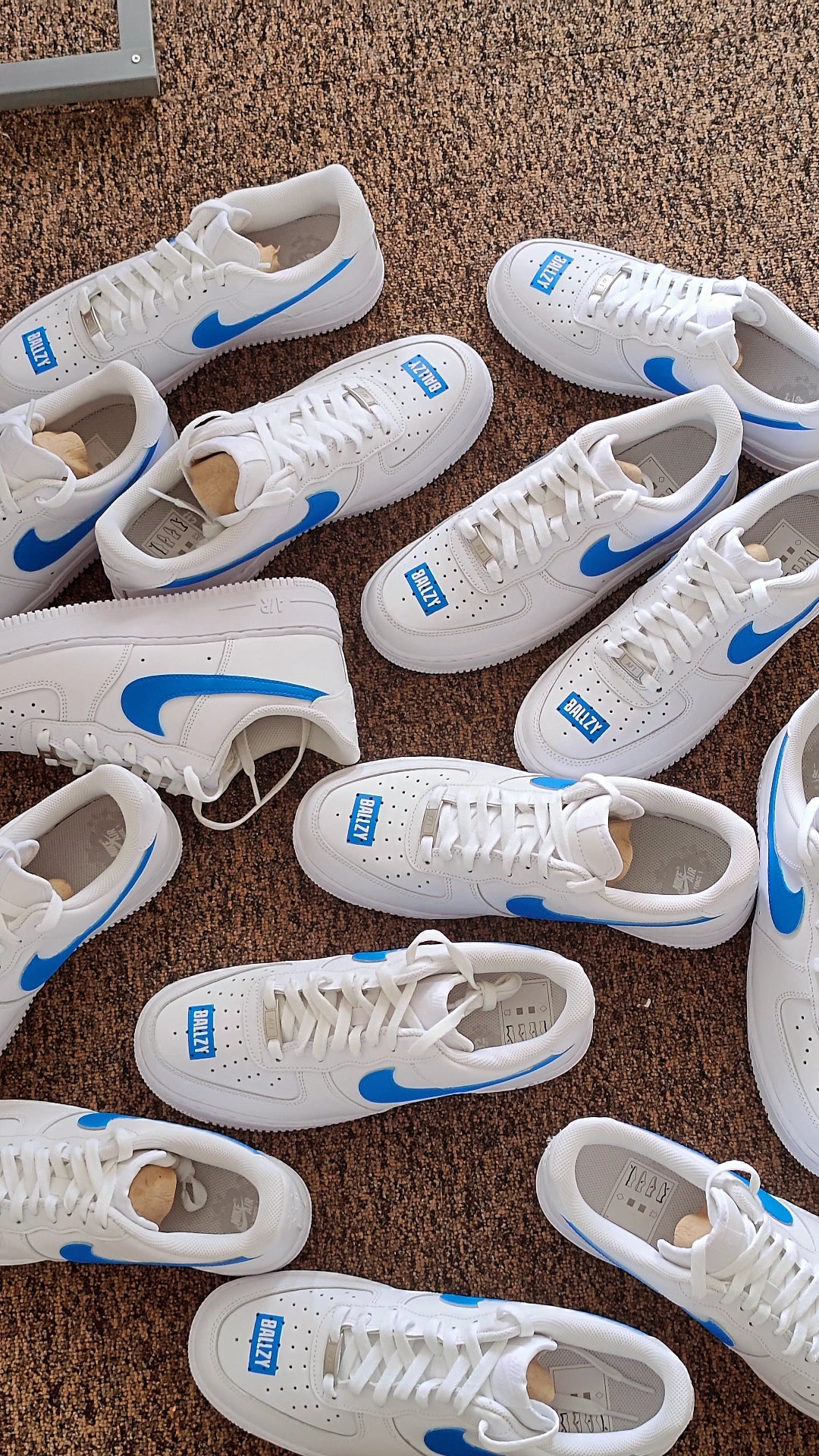 custom air force 1 sneakers with a blue box logo design and blue nike logos, picture features multiple pairs of custom nike air force 1s