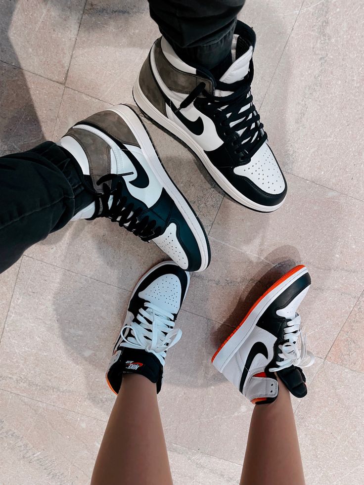 Two pairs of matching jordan 1 sneakers in white black and brwon 
