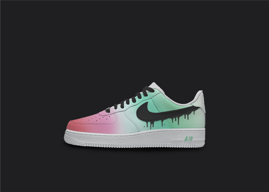 The image is of a Custom Nike Air force 1 sneaker on a street background. The white custom nike sneaker have a mint green fade and black dripping nike swoosh on the sides. 