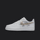 The image is of a Custom Nike Air force 1 sneaker on a blank black background. The white custom sneaker has a beige floral nike logo design.