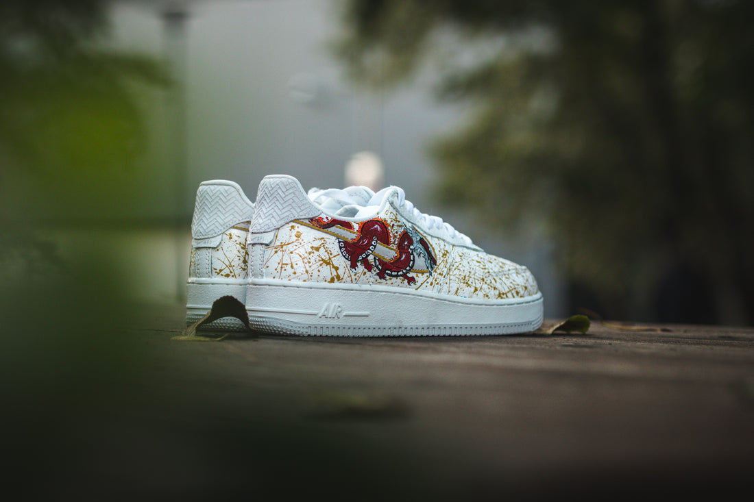 Custom dragon nike air force 1s with a gold splatter