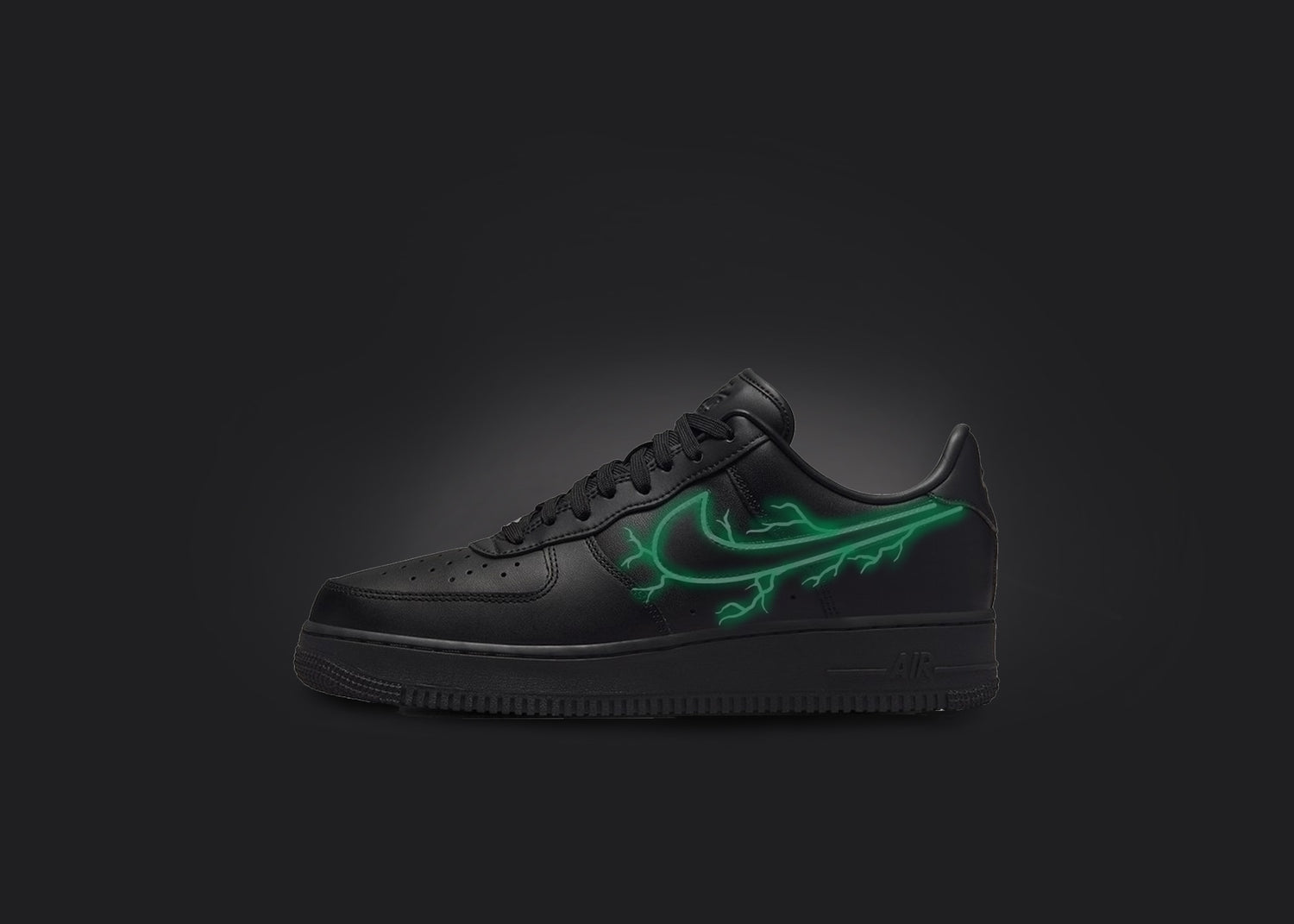 The image is featuring a custom black Air force 1 sneaker on a blank black background. The black nike sneaker has a custom green lightning design on the nike logo. 