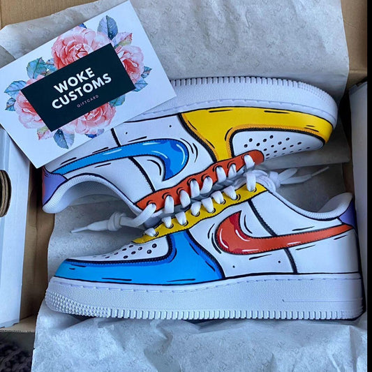 A pair of custom Air Force 1 sneakers with a colorful design featuring yellow, blue, and red panels, displayed in a shoebox alongside a card from Woke Customs.