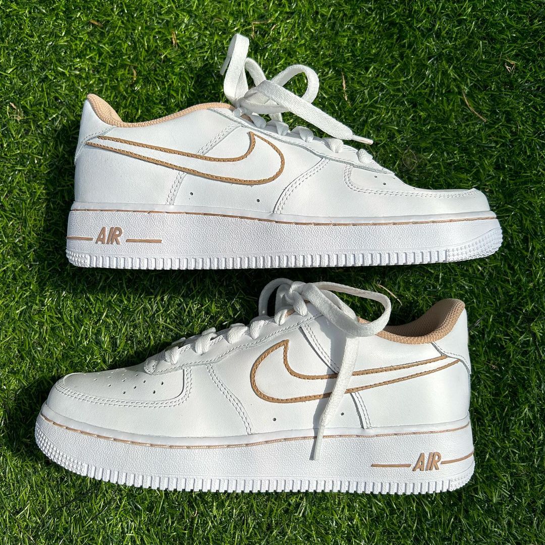pair of nike air force 1s with a beige swoosh outline on the nike swoosh, beige 