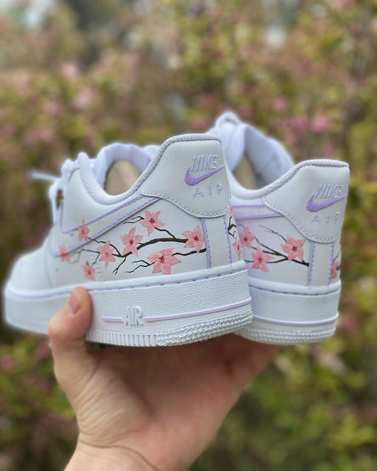 back view nike air froce 1s with a handpainted cherry blowwoming desing in pink 