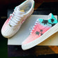 Custom Nike Air Force 1 sneakers with a soft gradient in pink and teal, adorned with black palm tree silhouettes for a tropical beach theme.