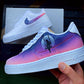 Side view of a custom-painted Nike Air Force 1 shoe with a serene night sky design, showcasing a figure on a swing in front of a full moon. The sneaker features soft pink and purple gradients with starry accents to create a cosmic vibe.