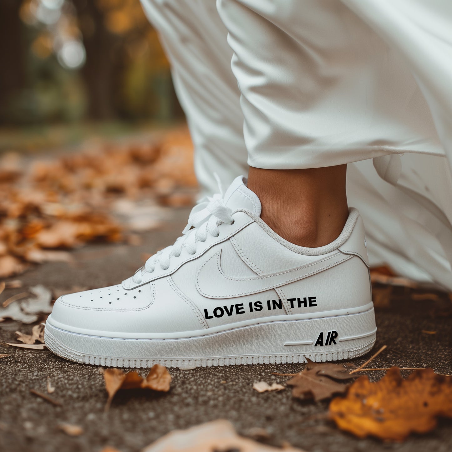 woman with white dress wearing nike air force 1 white sneaker with black text written on the tside saying "love is in the air" with black color