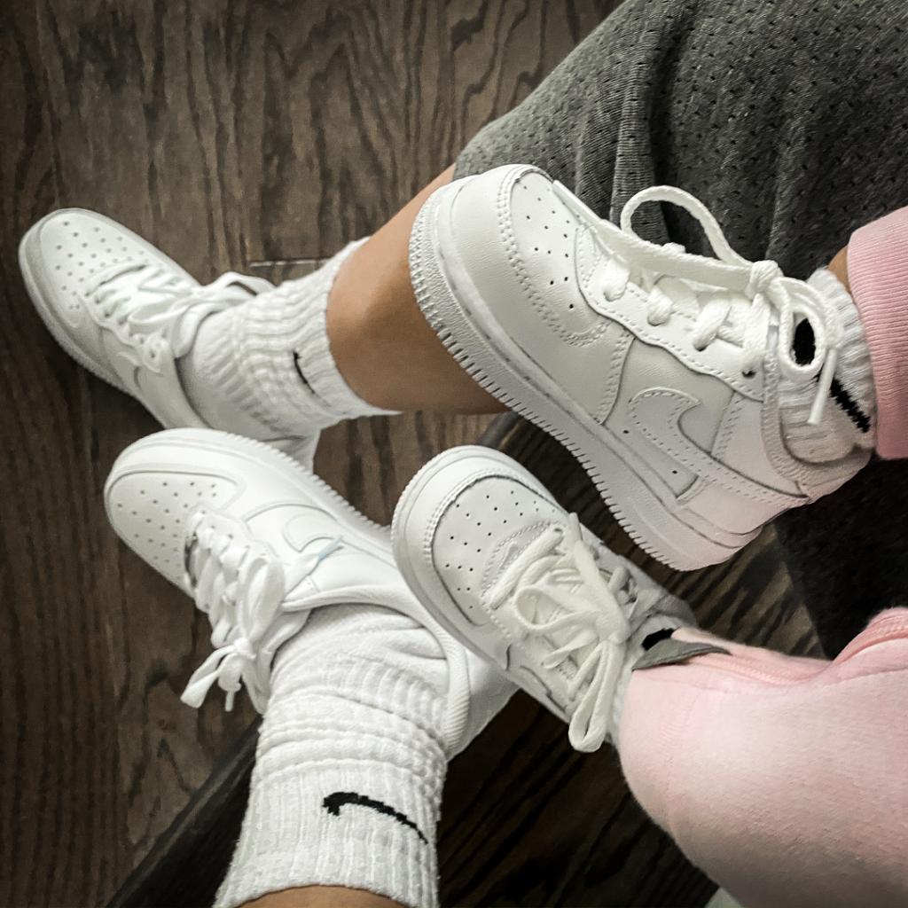 mom and daughter wearing matching white nike air force 1 sneakers 