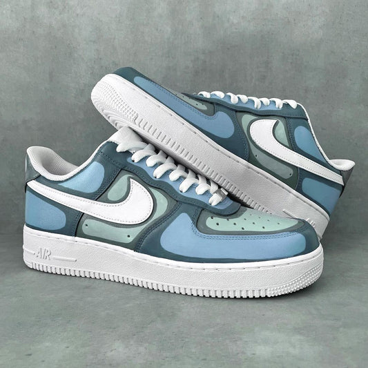 White Nike Air Force 1 sneakers with a pop art-inspired design, using bold black outlines and grayscale shading for a cartoon effect.
