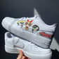 a pair of white nike air force 1s with a powerpuff girls design on the outside sections of the sneakers. Blank gray shadow wall on the background