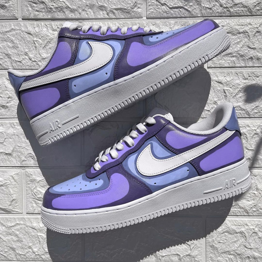 Custom Nike Air Force 1 sneakers featuring a unique abstract patchwork design in shades of purple and blue, inspired by modern art.