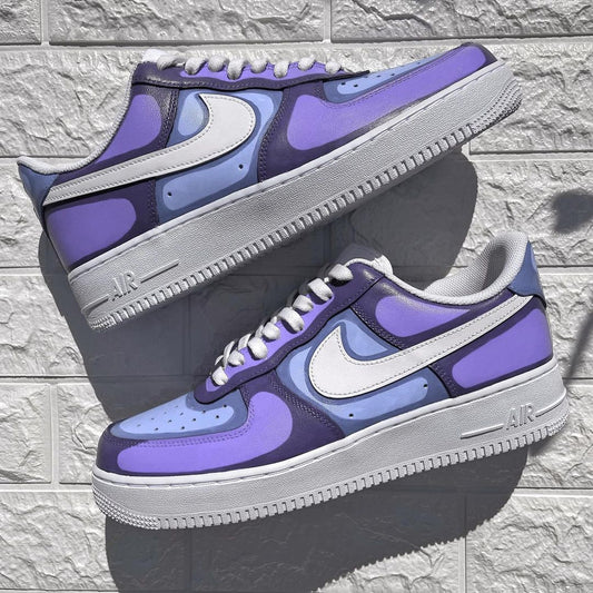 Custom Nike Air Force 1 sneakers featuring a unique abstract patchwork design in shades of purple and blue, inspired by modern art.