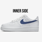 nike air force 1 side view, over the sneaker text "inner side" blak white background. Sneaker has a navy blue painted nike swoosh logo 