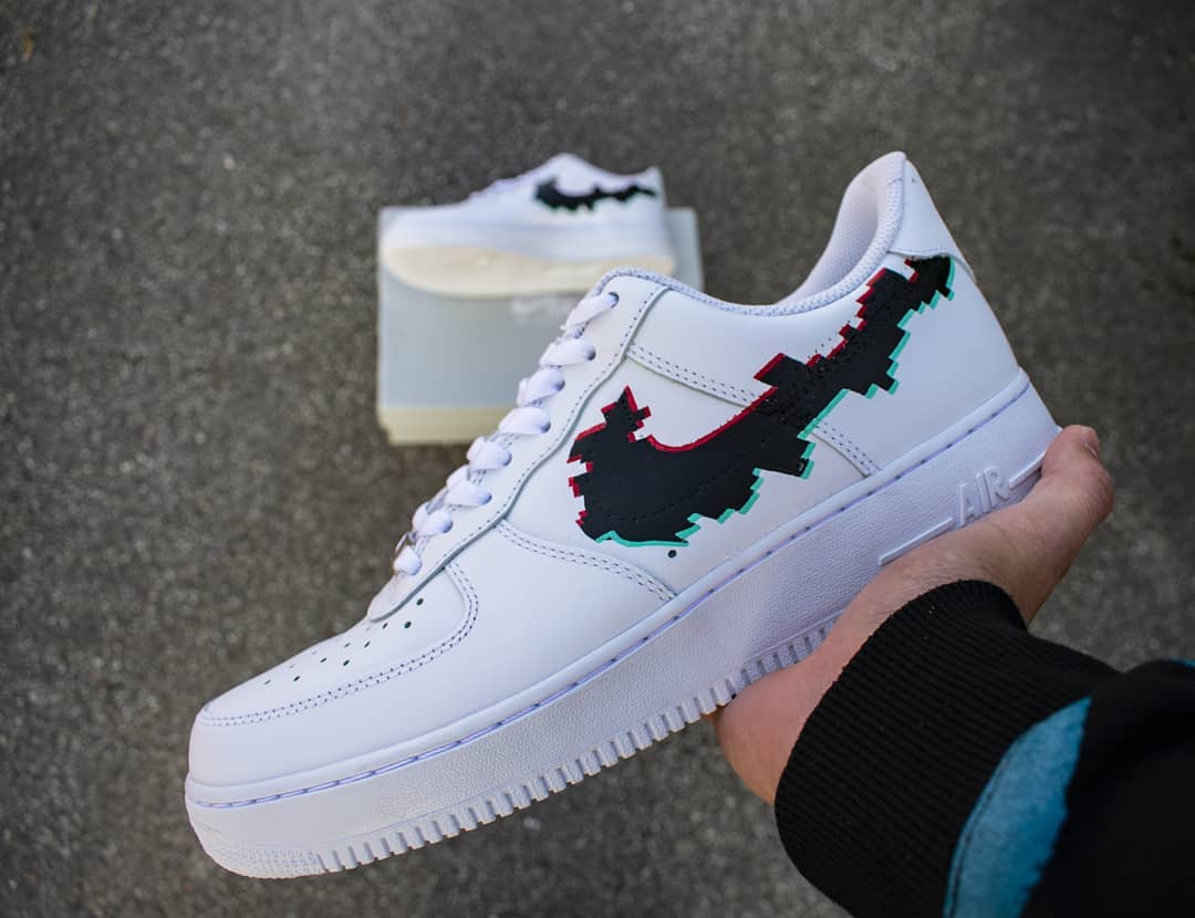 a pair of custom black glitch logo design air force 1 sneakers custom hand painted design