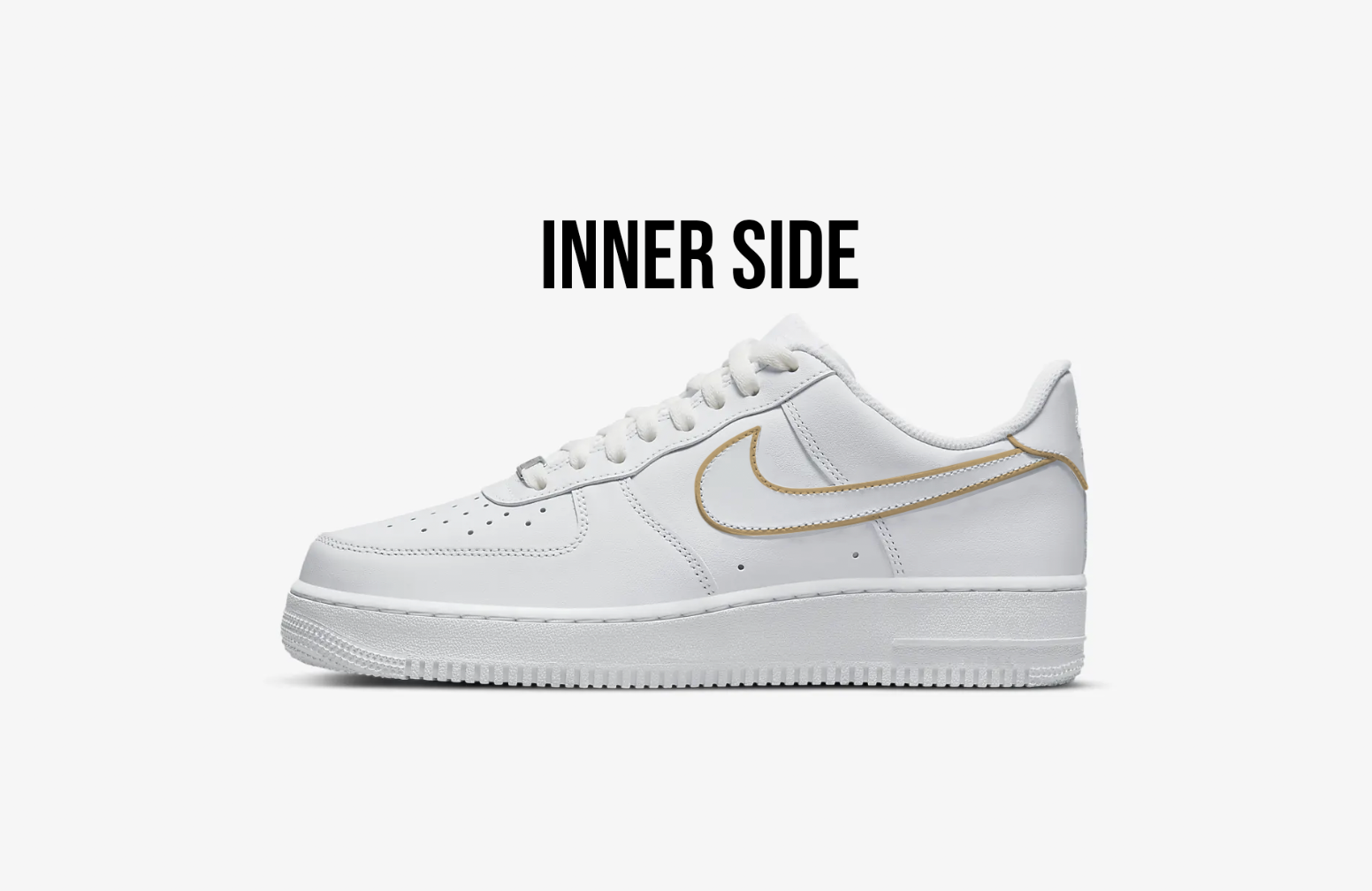 Inner side of white nike air force 1s, nike logo is outlined in gold