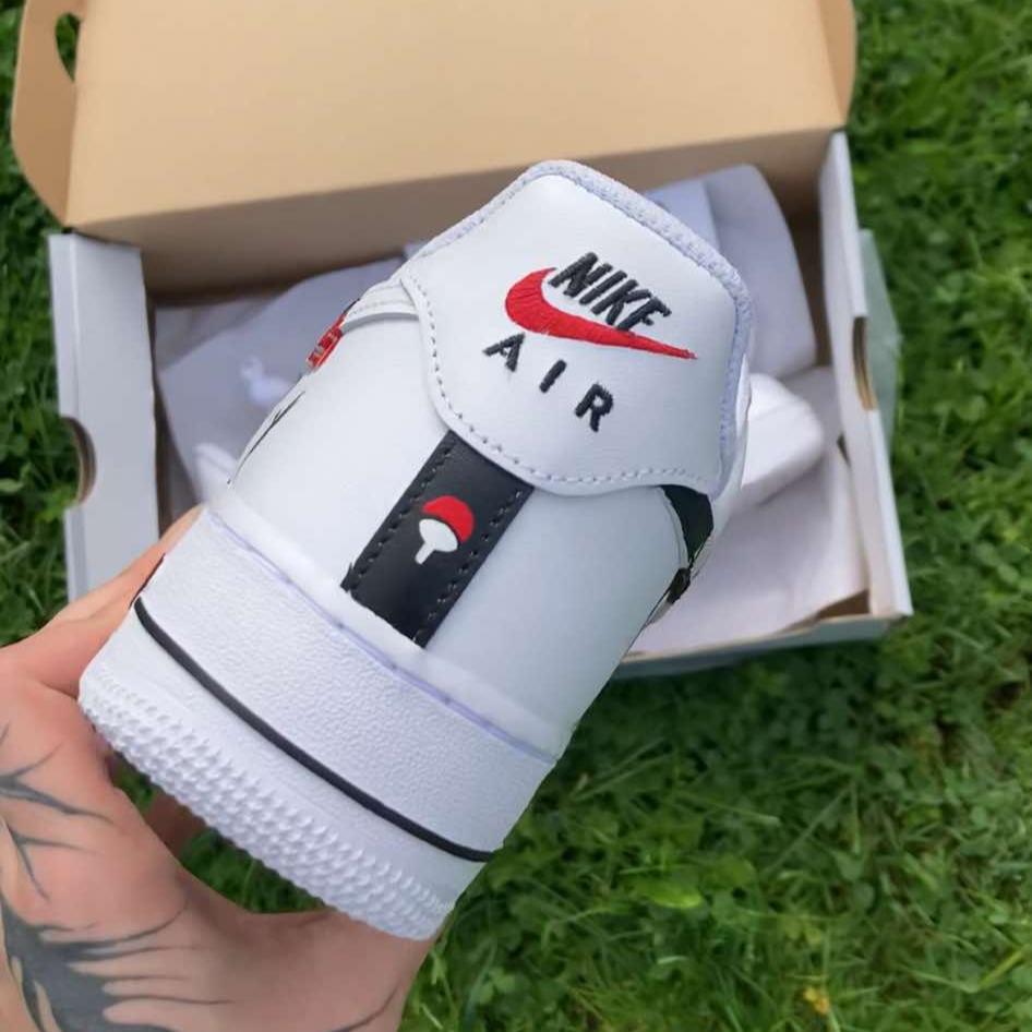 Back view of custom Air Force 1s with Itachi Uchiha design on heel tab, featuring the Uchiha clan symbol and Nike Air logo, hand-painted by Woke Customs.