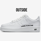 white nike air force 1 sneaker sideview with black text love is in the air on the side of the sneaker