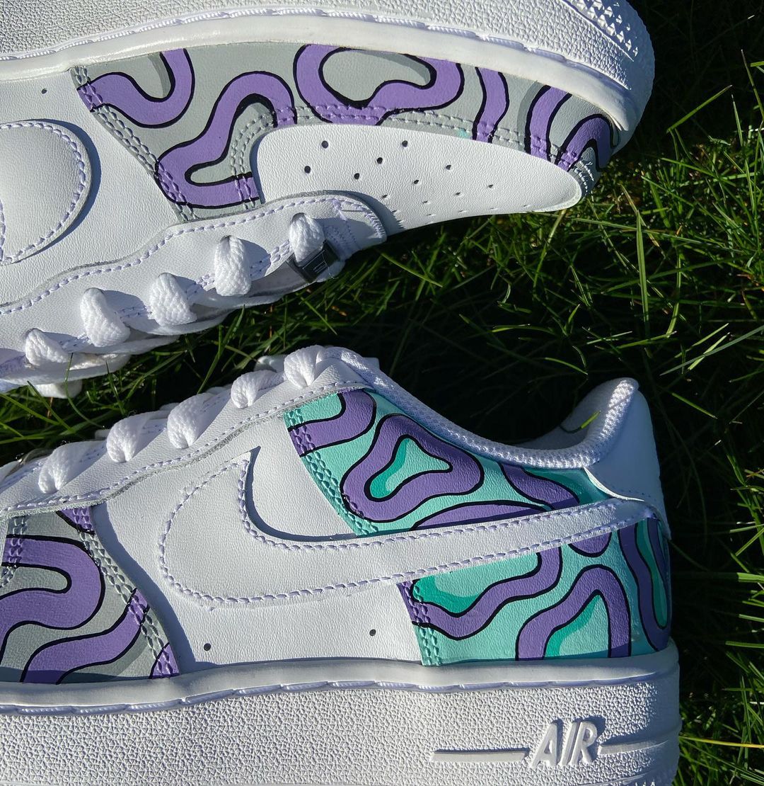 Customized Nike shoes with a blend of mint green and lavender, hand-painted in a psychedelic swirl pattern that turns the Air Force 1 into a striking statement piece.