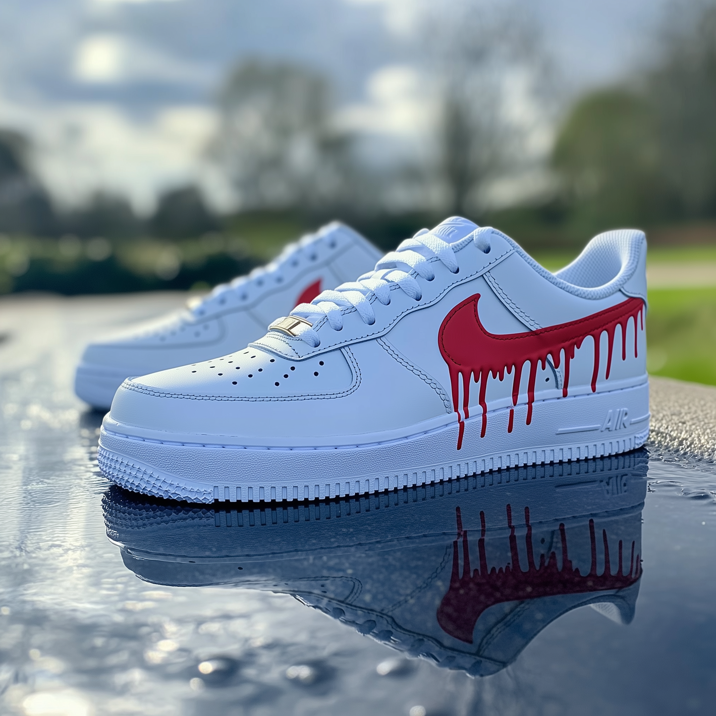 Close-up of custom Nike Air Force 1 sneakers with a white leather base and a red dripping Swoosh design.