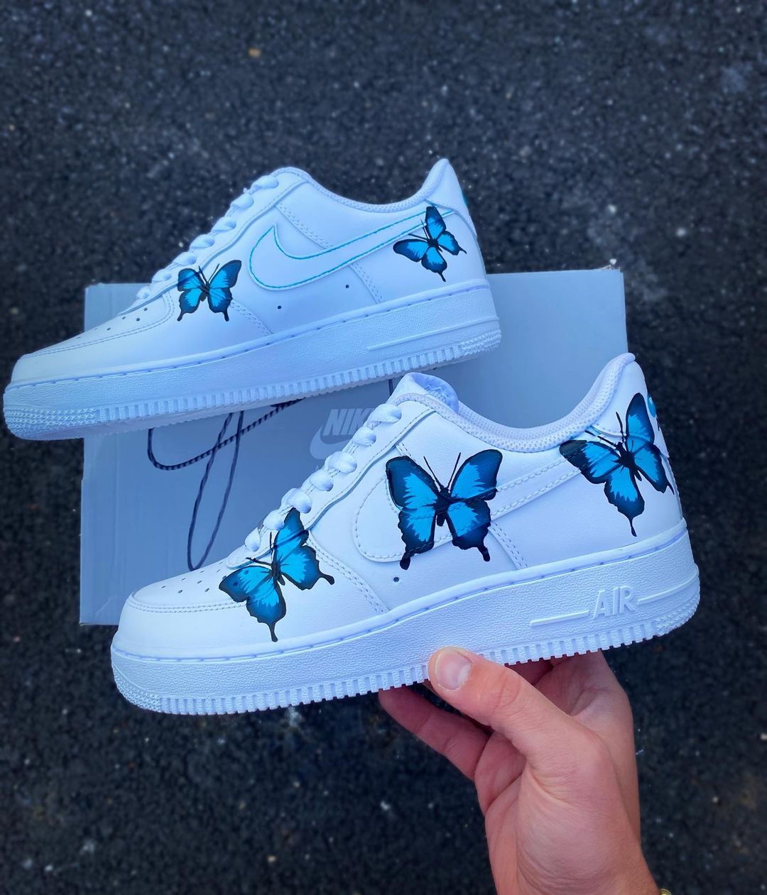 Side view of custom Nike Air Force 1 showcasing multiple blue butterflies on a clean white background.