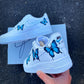 Custom Nike Air Force 1 sneakers with handpainted blue butterfly designs, adding a vibrant touch to the white base.