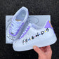 Pair of custom Friends-themed Air Force 1 sneakers with iconic Friends logo and “We were on a break” quote, purple detailing.