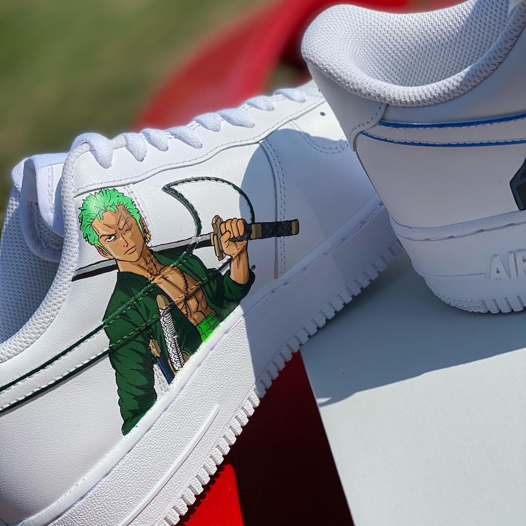 Custom Nike Air Force 1 sneakers featuring a handpainted illustration of a green-haired anime swordsman, adding a dynamic look to the design.