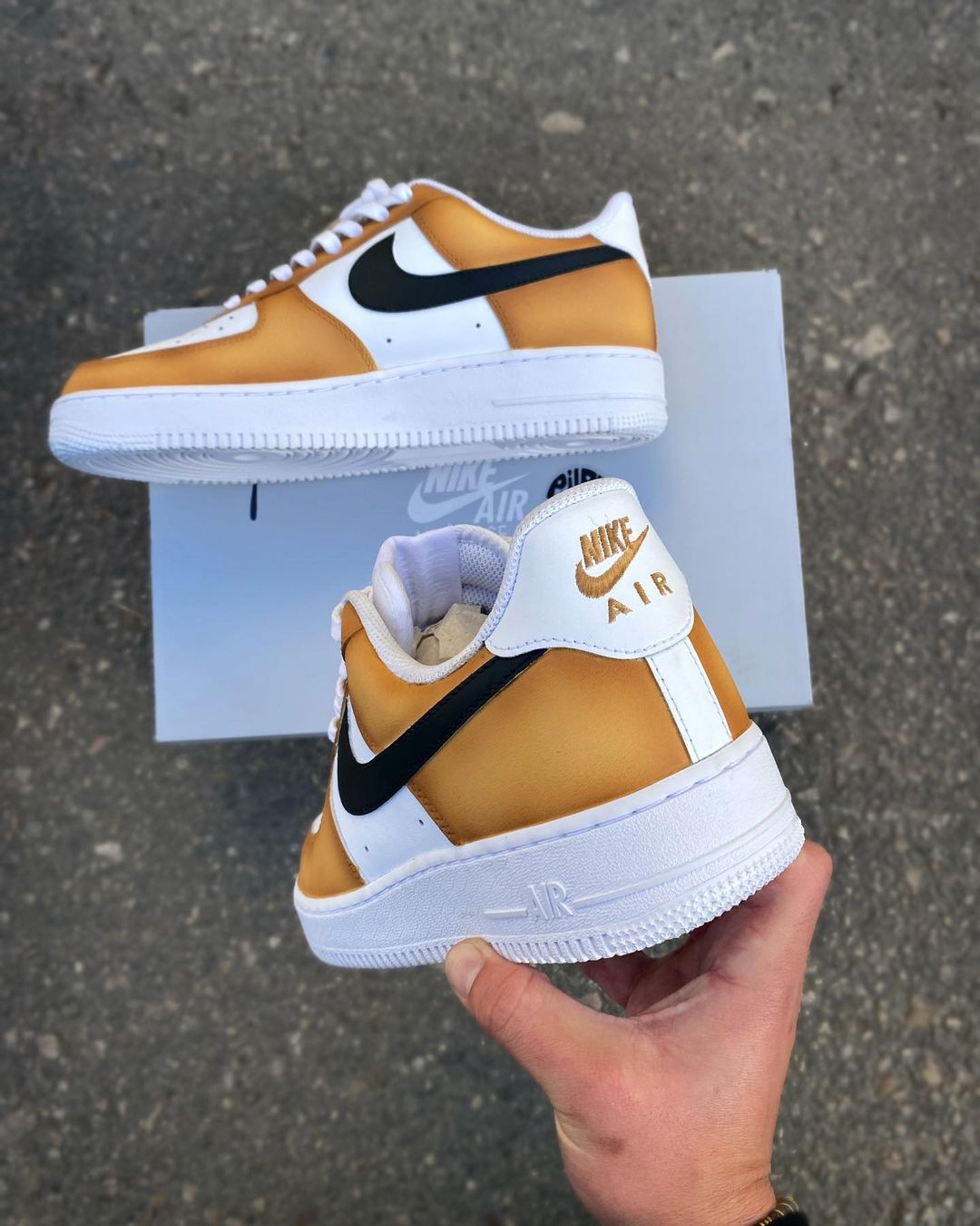 Side view of custom Nike Air Force 1 with a mustard yellow upper and black swoosh, creating a striking contrast.