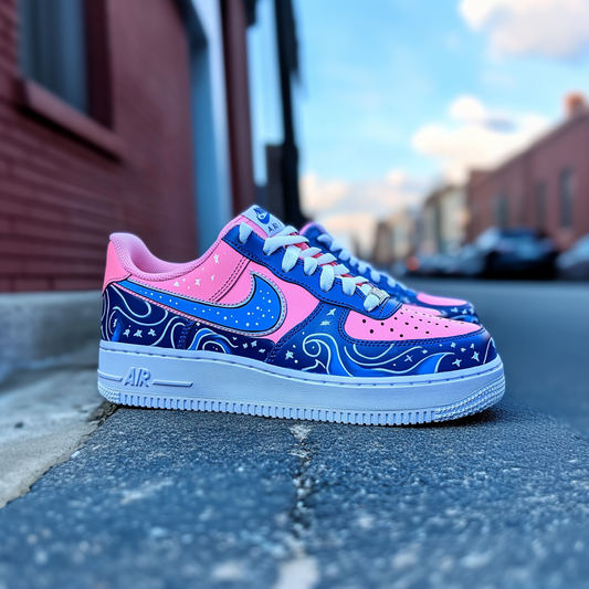 Close-up of a custom Nike Air Force 1 sneaker with a pink and blue cosmic wave design, featuring hand-painted stars and swirls.