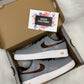 Close-up of custom Nike Air Force 1 sneakers featuring a bold gray-and-orange outline effect on a sleek leather base