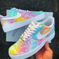 Custom Nike Air Force 1 sneakers featuring a pastel cloud design with soft rainbow colors, white Nike swoosh.