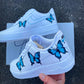 Custom Air Force 1 with realistic blue butterfly illustrations, emphasizing the contrast against the white sneaker.