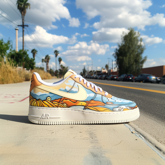 Close-up of custom Nike Air Force 1 sneakers featuring a hand-painted sunset landscape with rolling hills and a pastel sky.