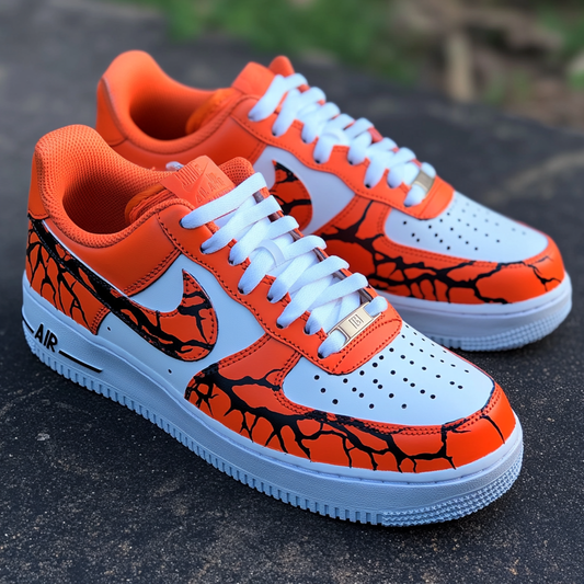 Close-up of custom Nike Air Force 1 sneakers featuring a lava crack pattern in fiery orange and deep black.