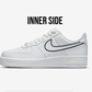 side view of nike air force 1 sneaker inner side, with nike logo swoosh having a black outline, white background