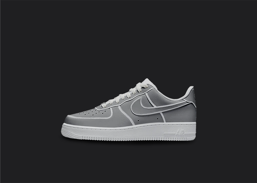 The image is featuring a Custom cartoon Air force 1 sneakers on a blank black background. The white nike sneaker has a gray cartoon design on the entire air force sneaker. 