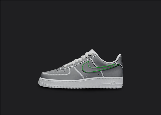 The image is featuring a Custom cartoon Air force 1 sneakers on a blank black background. The white nike sneaker has a black and green swoosh design on the entire air force sneaker. 
