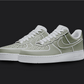 The image is featuring a Custom pastel green cartoon Air force 1 sneaker pair on a blank black background. The white nike sneakers have a pastel green cartoon design on the entire air force sneakers. 