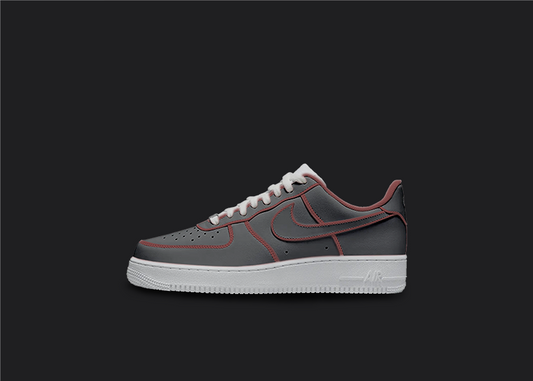 The image is featuring a Custom cartoon Air force 1 sneakers on a blank black background. The white nike sneaker has a black and red design on the entire air force sneaker. 