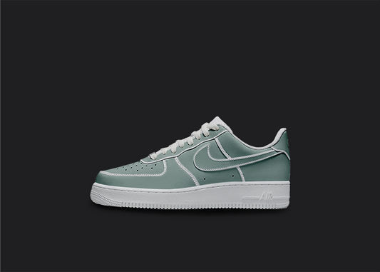The image is featuring a Custom cartoon Air force 1 sneakers on a blank black background. The white nike sneaker has a green cartoon design on the entire air force sneaker. 