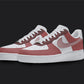 The image is of a Custom Nike Air force 1 sneaker pair on a blank black background. The custom sneakers are painted in lighter and darker red colors. 