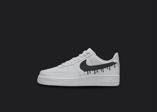 The image is of a Custom Nike Air force 1 sneaker on a blank black background. The white custom sneaker have a black dripping design. 