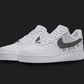 The image is of a Custom Nike Air force 1 sneaker pair on a blank black background. The white custom sneakers have a black dripping design. 