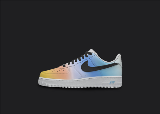 Custom Nike air force 1s are displayed on a dark blank background. The sneakers feature a black custom design with white splatter all over the sneakers. The Nike logo is painted in black whereas the other parts of the snaekers feature blue, orange and yellow pastel tones.