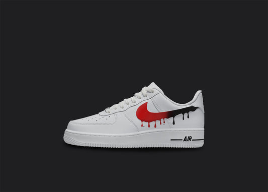 The image is of a Custom Nike Air force 1 sneaker on a blank black background. The white custom sneaker have a red and black dripping design. 