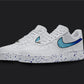 The image is of a Custom Nike Air force 1 sneaker pair on a blank black background. The white custom sneakers have a blue splatter covering the sole and the nike logo of the sneakers. Under the splatter the nike logo is made in a blue fade. 