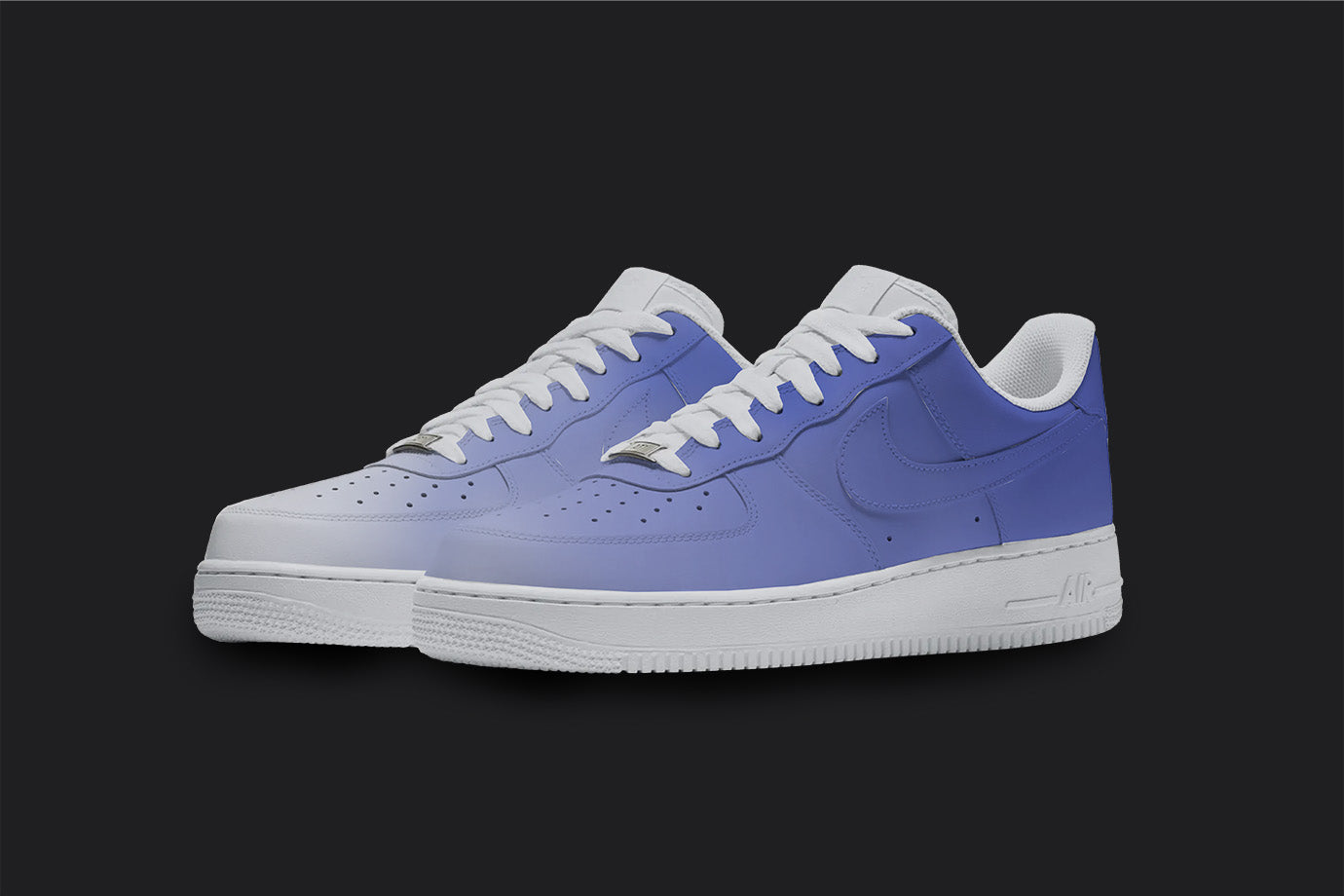The image is of a Custom Nike Air force 1 sneaker pair on a blank black background. The white custom sneakers have a blue fade all over design. 
