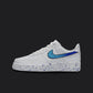 The image is of a Custom Nike Air force 1 sneaker on a blank black background. The white custom nike sneaker has a blue splatter covering the sole and the nike logo.  