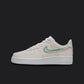 The image is of a Custom Nike Air force 1 sneaker on a blank black background. The white custom sneaker has a creme colorway with a mint nike logo. 